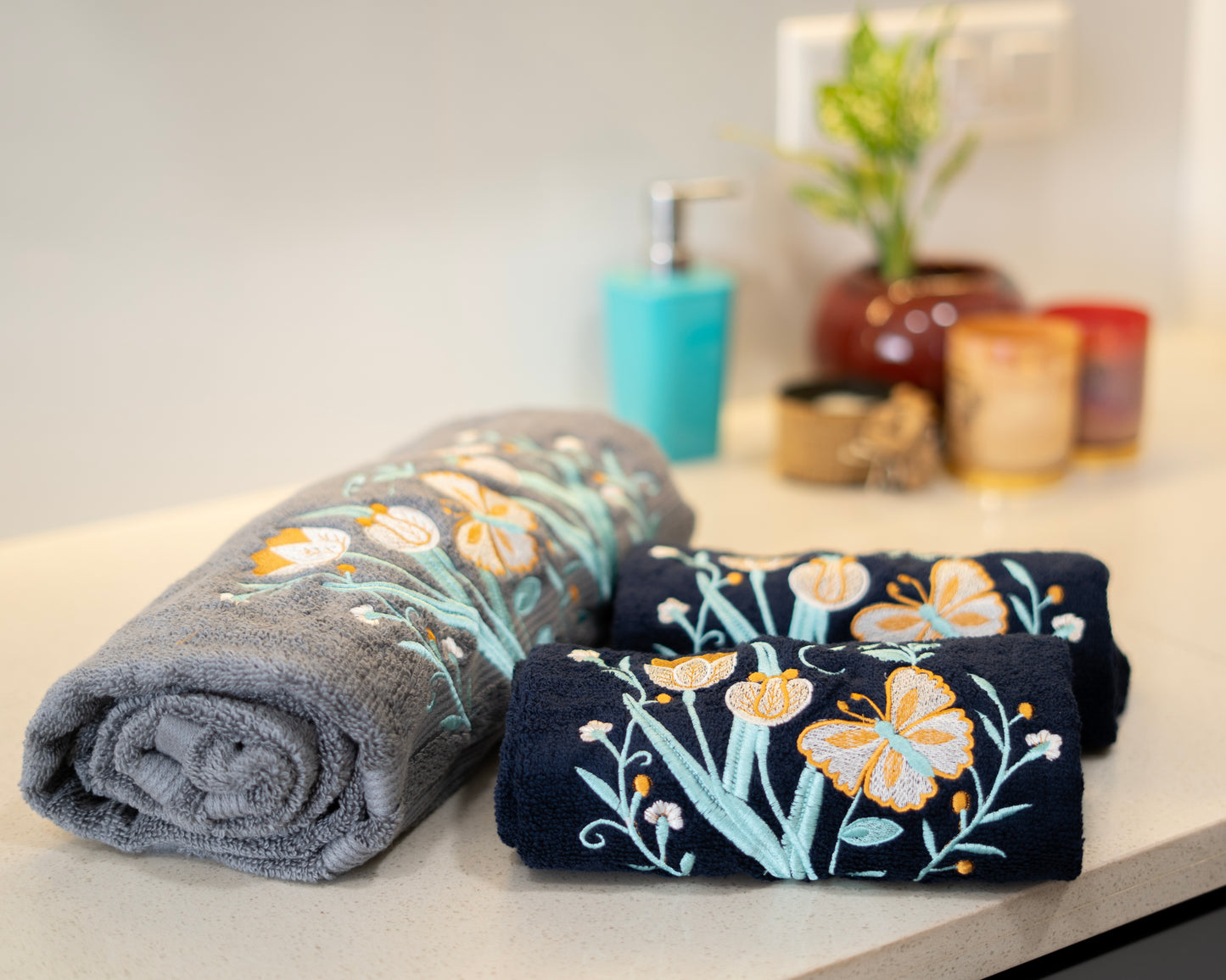 Two folded towels with floral patterns on a countertop.