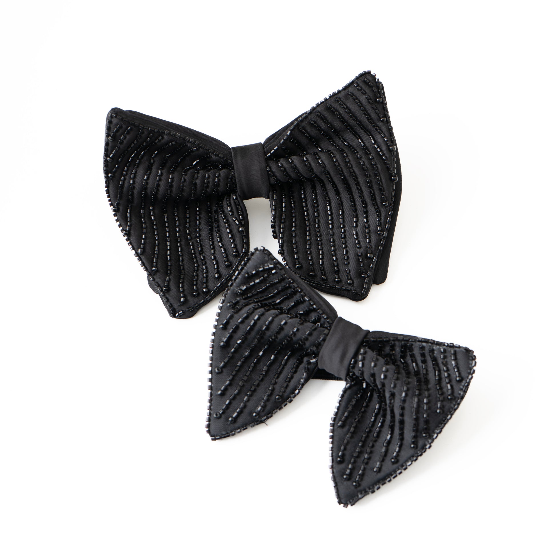 Two black ribbed bow tie on a white background