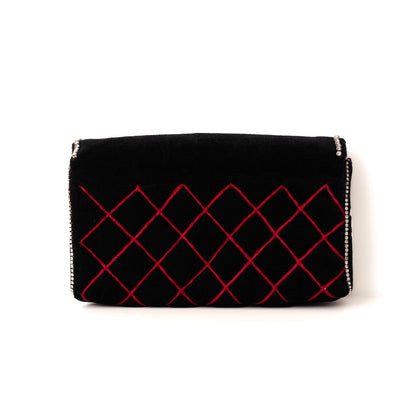 Black clutch with red geometric pattern on a white background