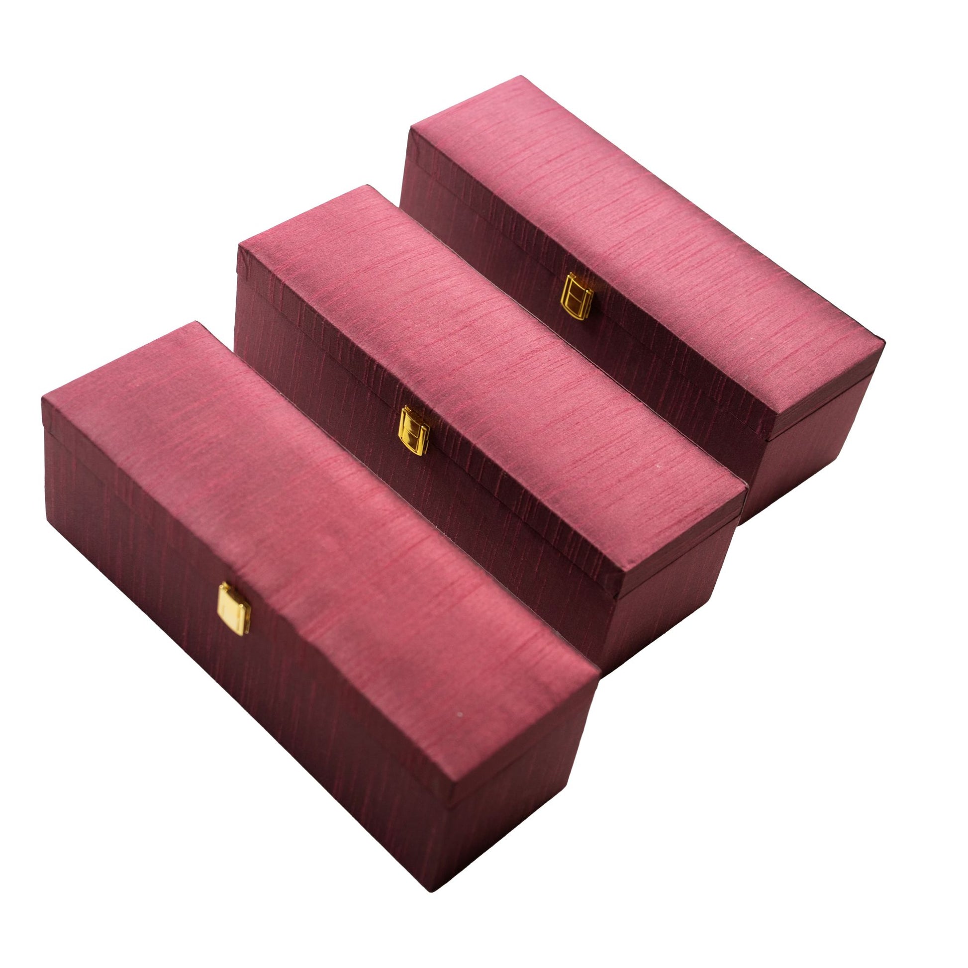 Three red jewelry boxes with gold clasps on a white background