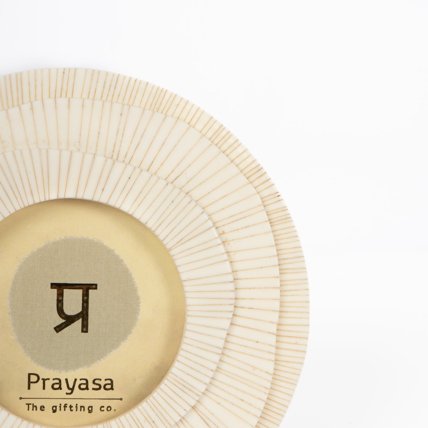 Round handmade item with 'Prayasa' branding on a white background