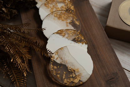 Decorative coasters with gold leaf on a wooden surface