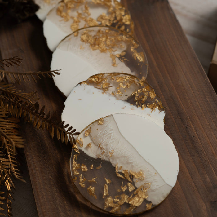 Decorative coasters with gold leaf on a wooden surface