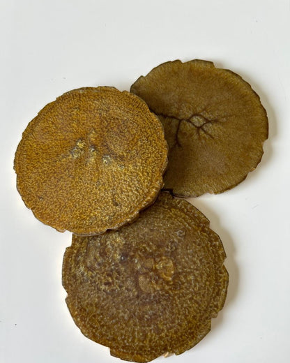 Three brown circular coasters on a white background