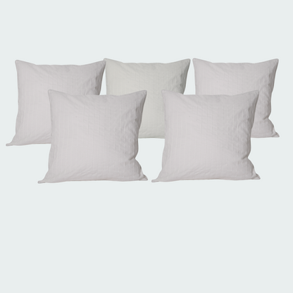 Set of five white pillows.
