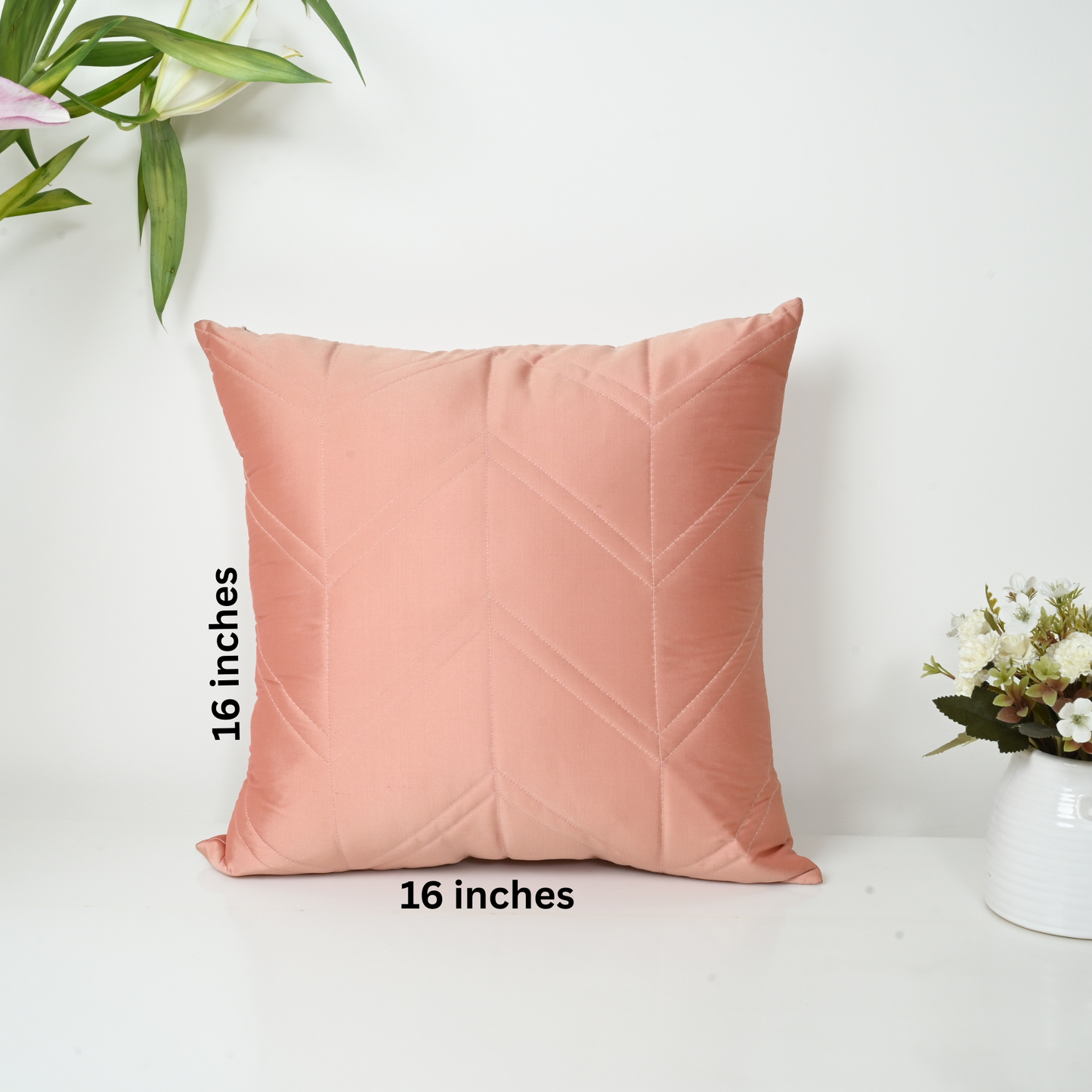 Pink pillow with chevron pattern on a white background, measurement text included.